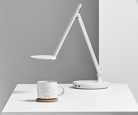 white light with circle wireless charging base on a white desk with a white and wood effect mug