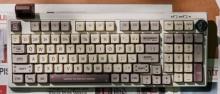 mechincal retro inspired keyboard with a range of cream, grey and dark pink/purple-hued keys