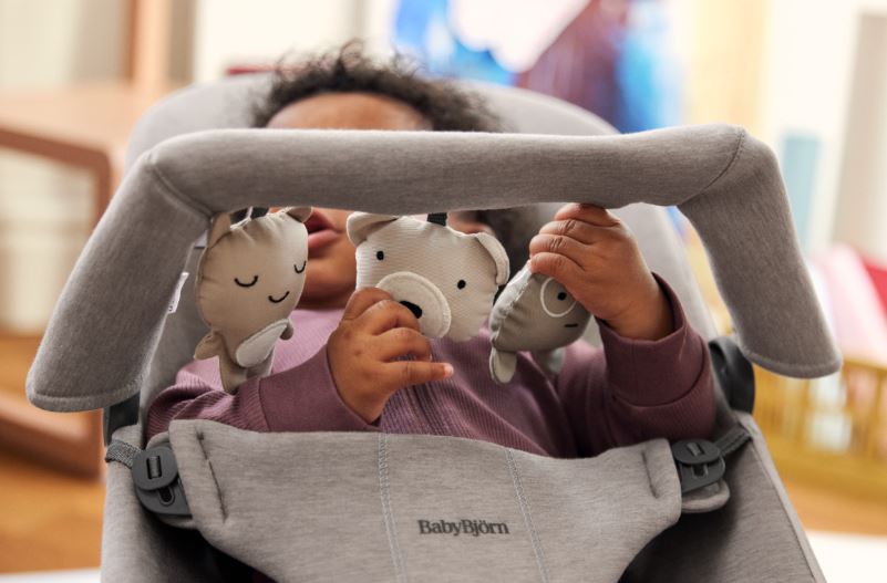 Bar that clips on to baby bouncer with three soft animal shaped toys for babies 