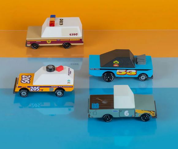 Image of four toys cars on an orange and blue surface. 