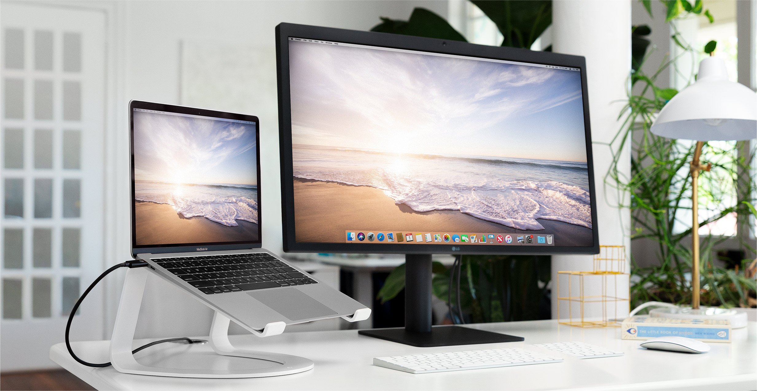 a laptop on the Curve, next to an Apple desktop computer