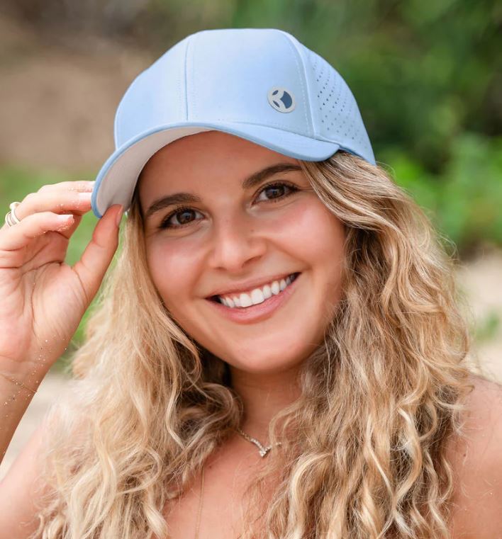 woman wearing a sky blue baseball cap