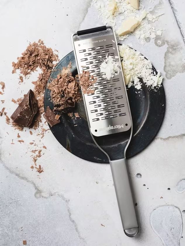 grater with chocolate shavings around it 