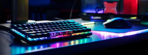 The Alloy Origins 60 keyboard, its keys glowing rainbow colours
