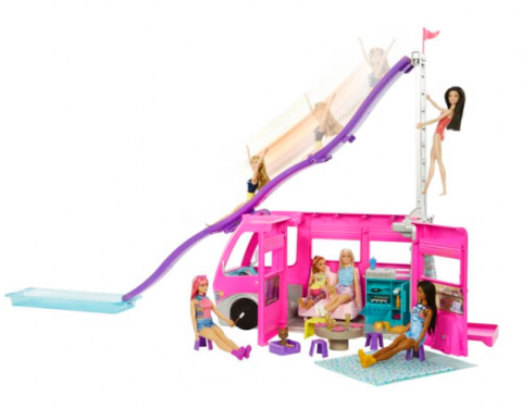 The Barbie Dream Camper with eight Barbies on a white background