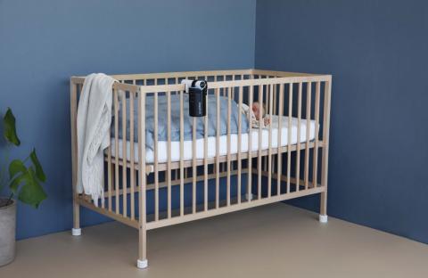 Sleepytroll Baby Rocker attached to a crib. 