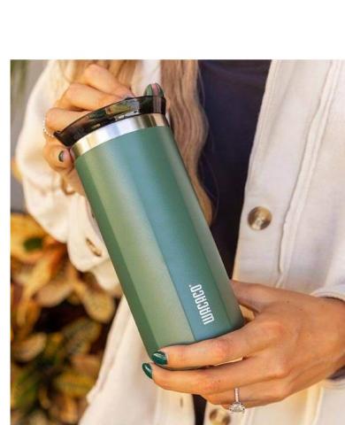 hands holding green travel coffee cup 