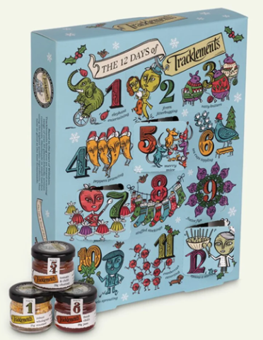 blue and floral patterned advent calendar box, with small condiment jars stacked in front 