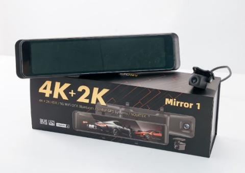 review mirror shaped dash camera on a box with an image of the same dash camera on it