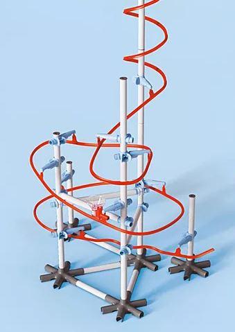 white vertical construction, with red tracks winding around it, on a light blue background 