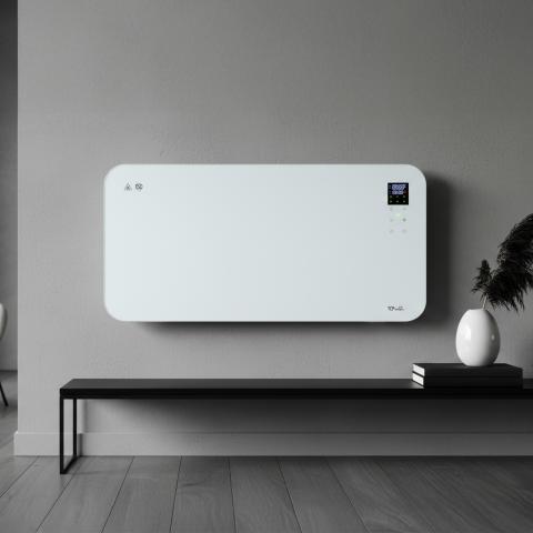 white wall mounted glass heater on a grey wall above a small table 