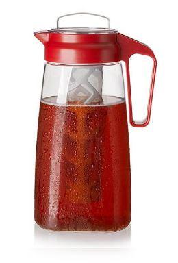 Clear pitcher filled with iced tea, featuring a red lid and handle. Inside the pitcher is a grey infuser basket. 