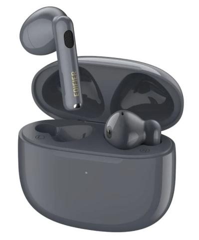 A pair of dark gray wireless earbuds with one earbud placed inside an open charging case and the other hovering above it. 