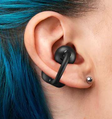 image of a person's ear with blue hair wearing a black wireless earbud featuring an clip-on design around the middle of the ear