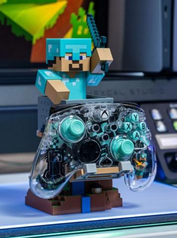 Minecraft themed phone and controller holder featuring a pixelated 'Steve' character wearing diamond armor and holding a sword. The controller and phone holder has a transparent Xbox controller on the front of it. 