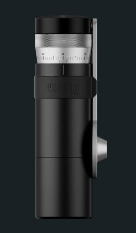 Image of cylindrical black coffee grinder with a silver dial on top marked with numbers for grind size, and a silver side mounted handle.