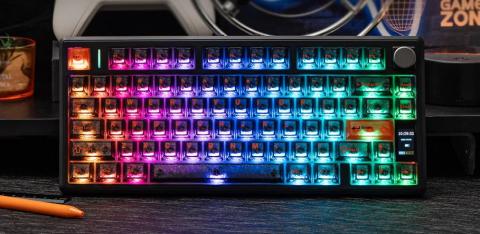 Image of black keyboard with RGB backlighting displaying a gradient of colours from red on the left to green on the right. The keyboard has a mini screen and rotary knob on the right hand side, 