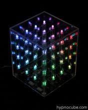 A Hypnocube lit up in rainbow LEDs in the dark
