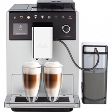 The silver Latte Select, with its milk compartment at its side, with two filled glass cups of coffee