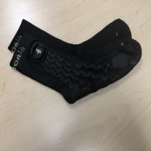 A pair of black socks, with the word 'sensoria' in small font around the band of each sock. There is also the Sensoria logo, 9 white dots, just underneath the writing. 