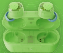 Skullcandy Transparency Earbuds in a vibrant green with blue accents. Sat in a green case./ 