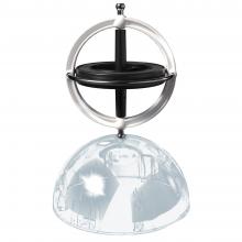 The gyroscope spinning on a see through sphere. 