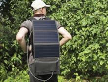 man wearing solar panel on rucksack 