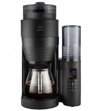 black coffee machine, with clear glass jar below and side control panel