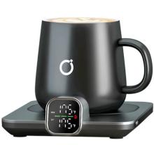 black mug on smart heating coaster which has a smart screen showing the cups temperature, all on a white background 