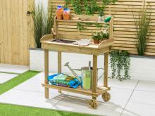 wooden potting station with wheels covered in plant pots and gardening tools, on a concrete patio