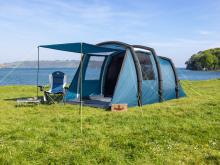 blue and black tent with canopy on a field background