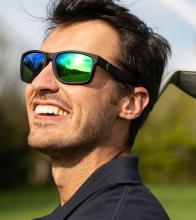 man wearing mirrored green-blue sun glasses