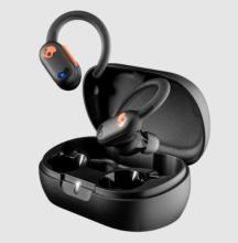 black earbuds with an orange skull design on the side above the black charging case 