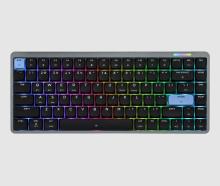 black keyboard on a white background, with blue ESC and ENTER keys, under each key are lights which deliver a rainbow effect glow across the keyboard