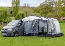 grey tent awning attached to a grey van in a camping field 