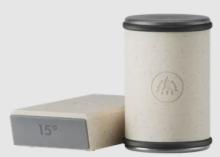 white and grey block, next to a cylinder which is white with a grey/silver top and bottom 