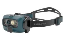 teal green headtorch with black head strap attached to it
