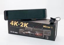 review mirror shaped dash camera on a box with an image of the same dash camera on it