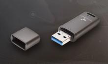 grey USB hard drive with the lid next to it on a grey background 