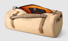 tan large duffel bag with orange interior and brown strap handles 