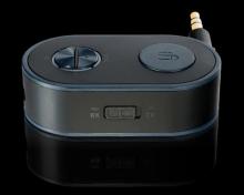 small oblong shaped adapter with buttons on the top and a headphone jack sticking out from the back