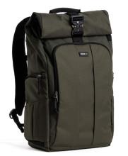 A dark green, rectangular backpack with a roll-top closure secured by a black buckle and a front zippered pocket. The backpack features padded shoulder straps, side zippered compartments, and a small logo patch centered on the front pocket.