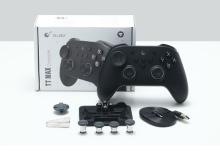 A black wireless gaming controller set with accessories including a detachable D-pad, four additional thumbsticks, a USB charging cable, and a clip, displayed in front of a white product box labeled "TT MAX Controller" by GuliKit. 