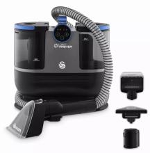 Image of black and blue spot cleaning vacuum unit, with flexible hose and three detachable cleaning attachments displayed beside it.  