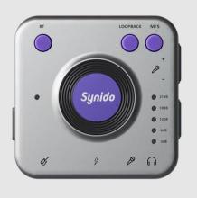 Image of compact audio interface device with a square silver body, with purple buttons, and a large purple dial in the center with "Synido" on it.